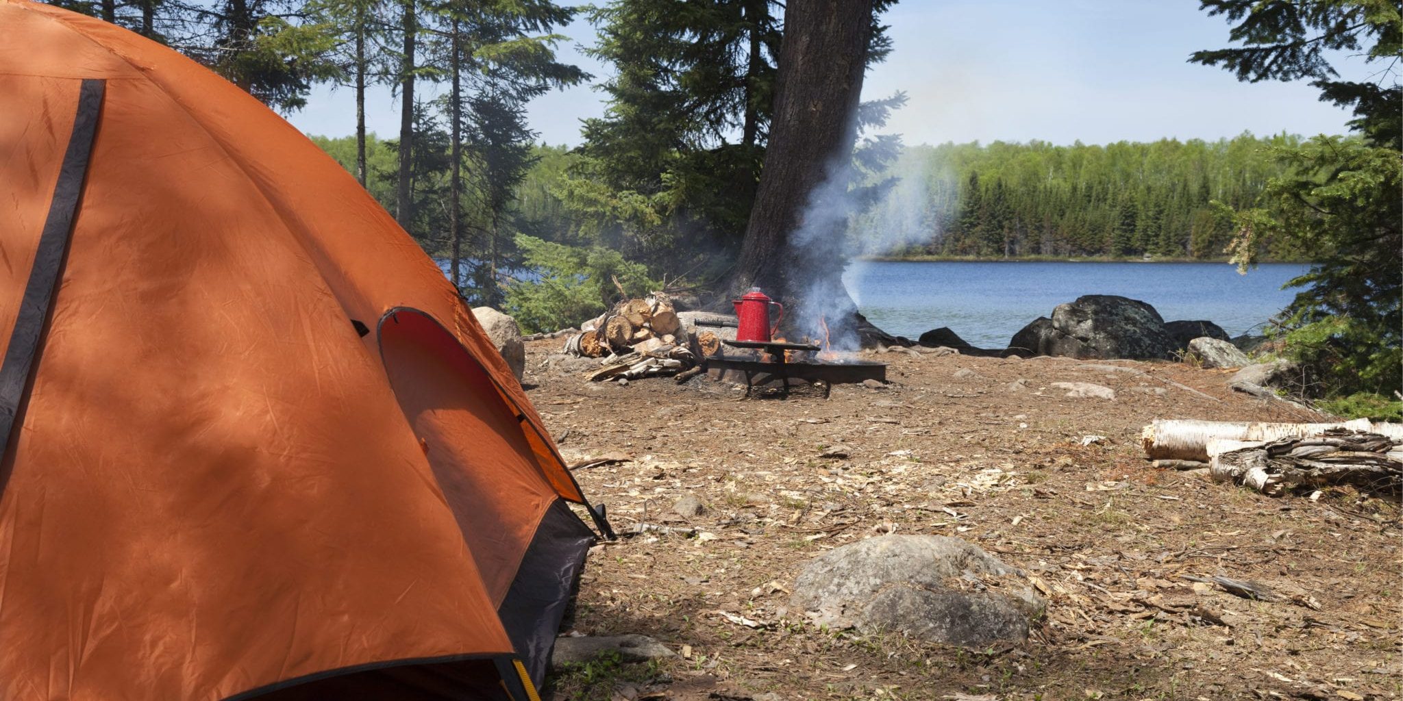 campsite-in-northern-minnesota-with-orange-tent-an-PNC27NG-scaled